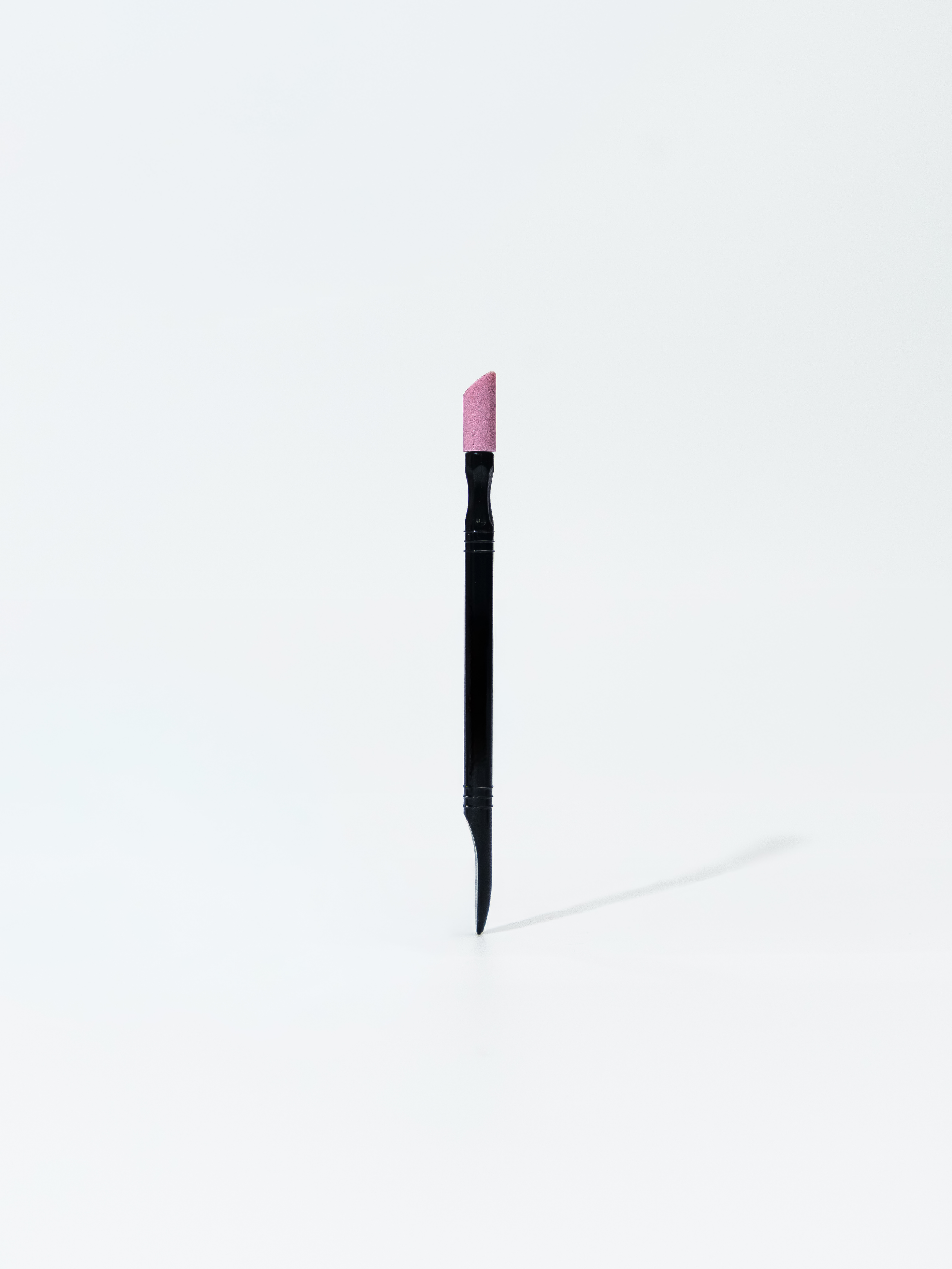 Plastic pusher with pumice stone for uncut manicure